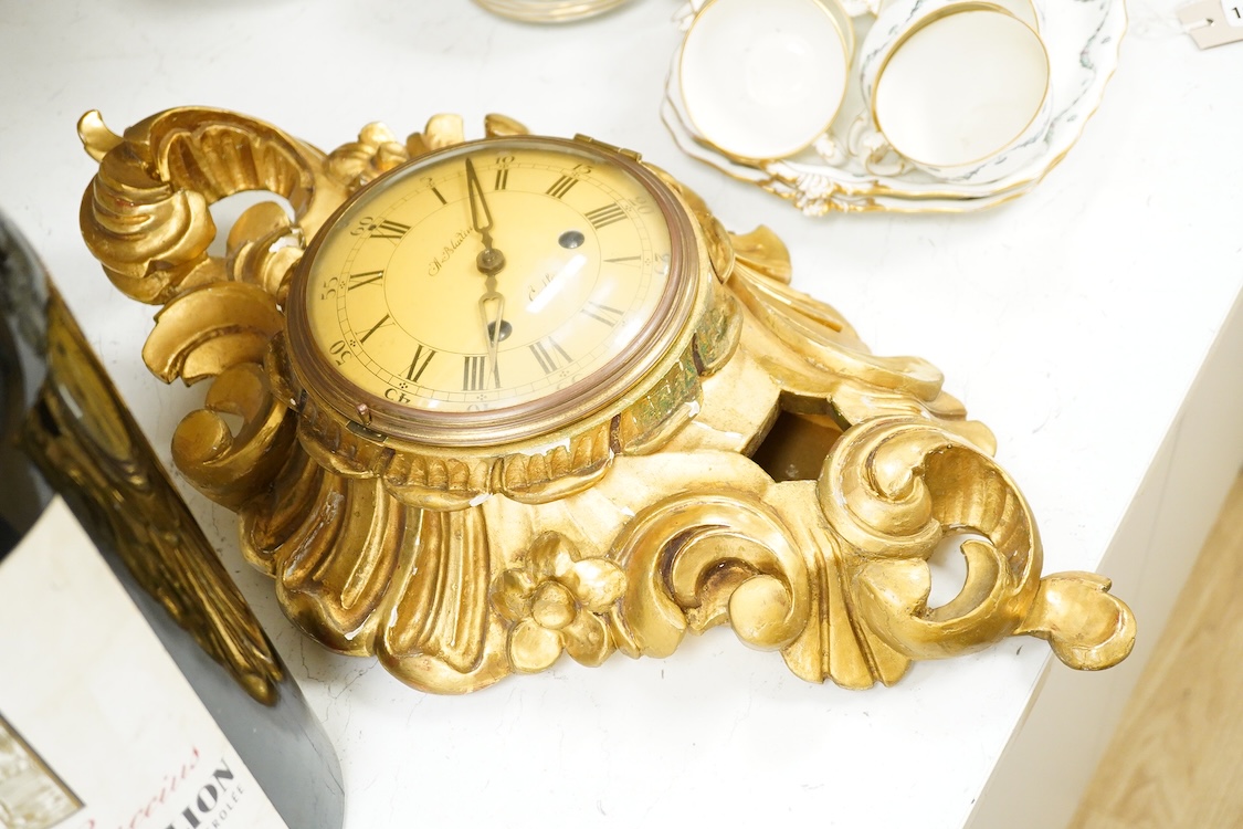 A carved giltwood cartel wall clock, 57 cm high
